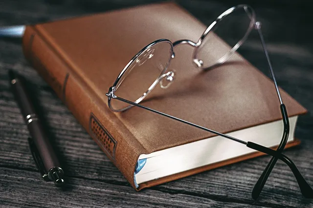 glasses, notebook, diary, pen, workspace, table. Customer interview answers: the one follow-up that makes them count