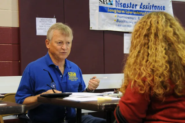 Woodstock, GA, October 1, 2009 -- At the Cherokee County State/FEMA Disaster Recovery Center, Small Business Administration Customer Service Representative Wade Geary provides information to a flood affected resident. FEMA and Small Business Administration are partners in recovery for those impacted. Customer interviews framework: plan the round, not the call