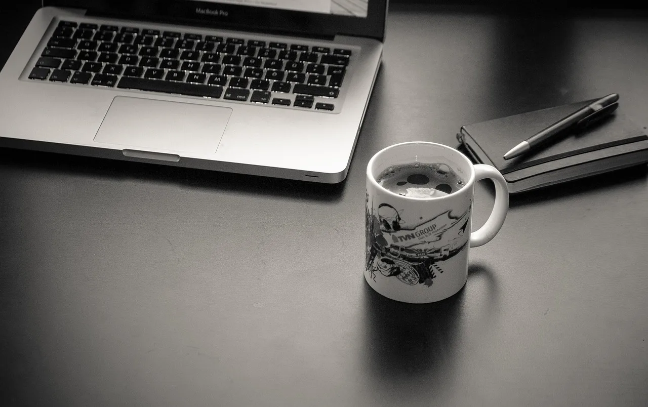 computer, laptop, workplace, mac, macbook, coffee cup, coffee, cup, coffee pot, ballpoint pen, pen, notebook, desk, work, home office, black-and-white. Minimum viable offers questions in four rounds