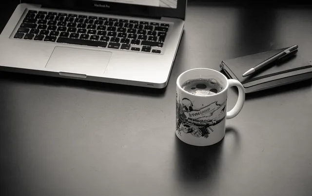 computer, laptop, workplace, mac, macbook, coffee cup, coffee, cup, coffee pot, ballpoint pen, pen, notebook, desk, work, home office, black-and-white. Minimum viable offers questions in four rounds